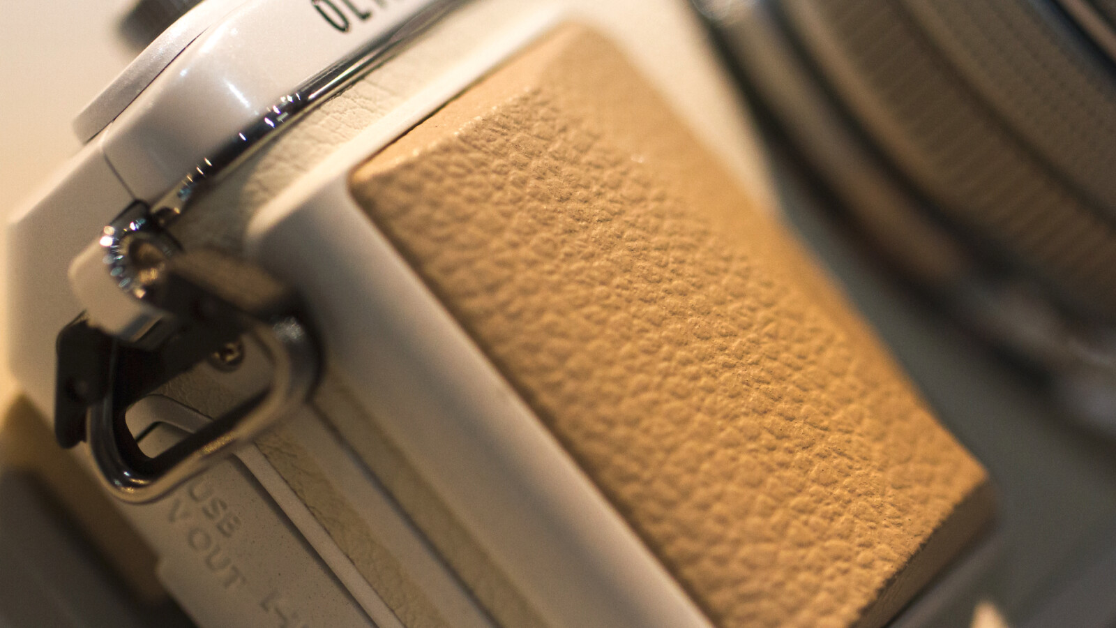 Um die Systemkamera besser halten zu können gibt es einen kleinen Kameragriff. Bei größeren Teleobjektiven dürfte dieser jedoch kaum ausreichend sein.